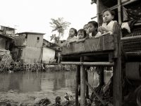 Young children outside their slum dwelling on the banks of the Ciliwung river in 2006 in South Jakarta.